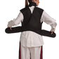 Back view of a female model wearing a coat apron with a flex back and an integrated thyroid guard. The apron is Jet black with a Bordeaux red center line and has unfastened velcro fasteners held in the model's hands. 