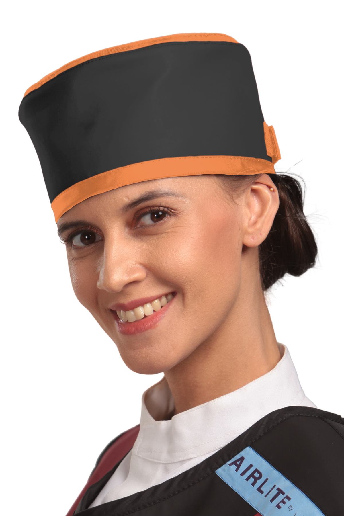 Up-close left-side frontal view of a female model wearing a radiation protection head shield. The head shield is Jet black with tangerine-colored lines around the lower and upper edges.