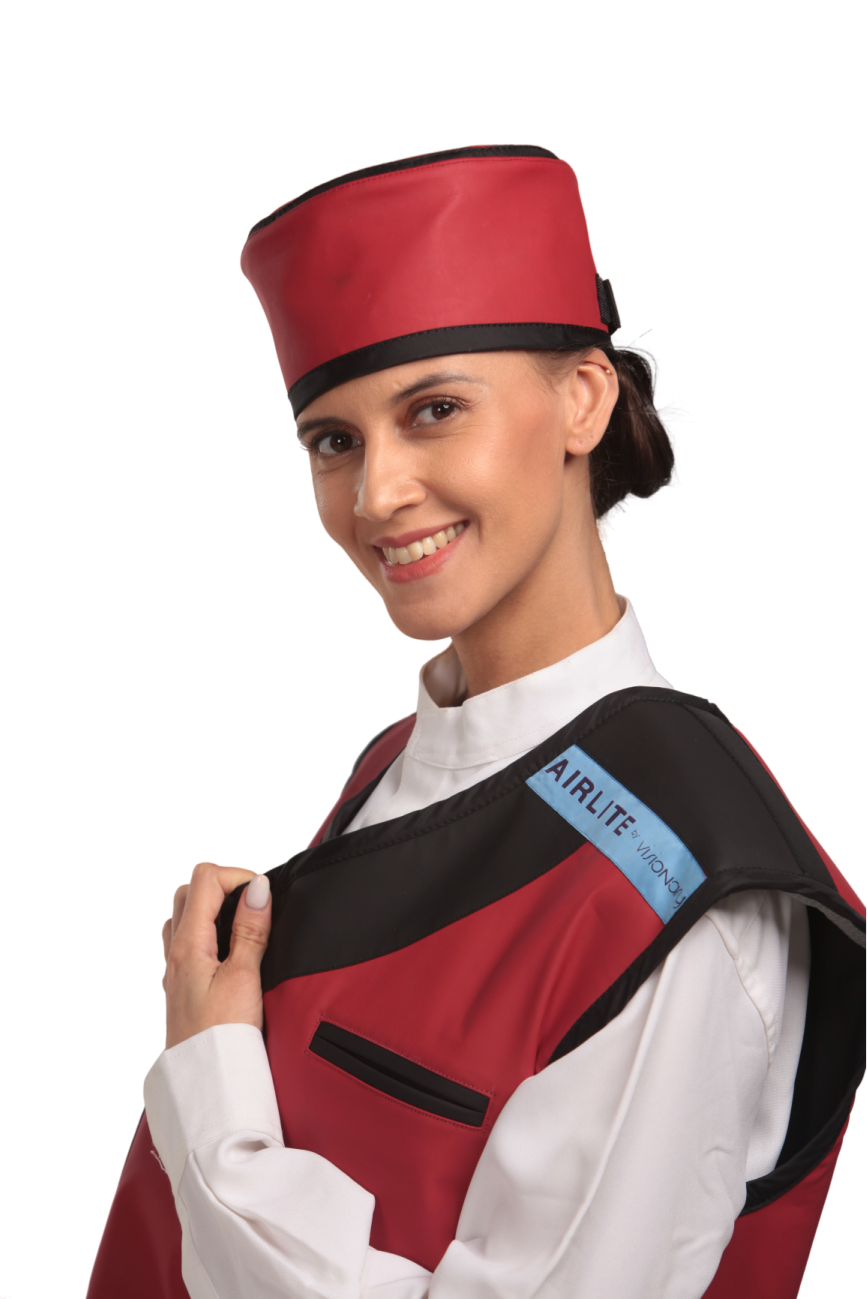 Up-close side view of a female model wearing a red radiation protection head shield and vest.