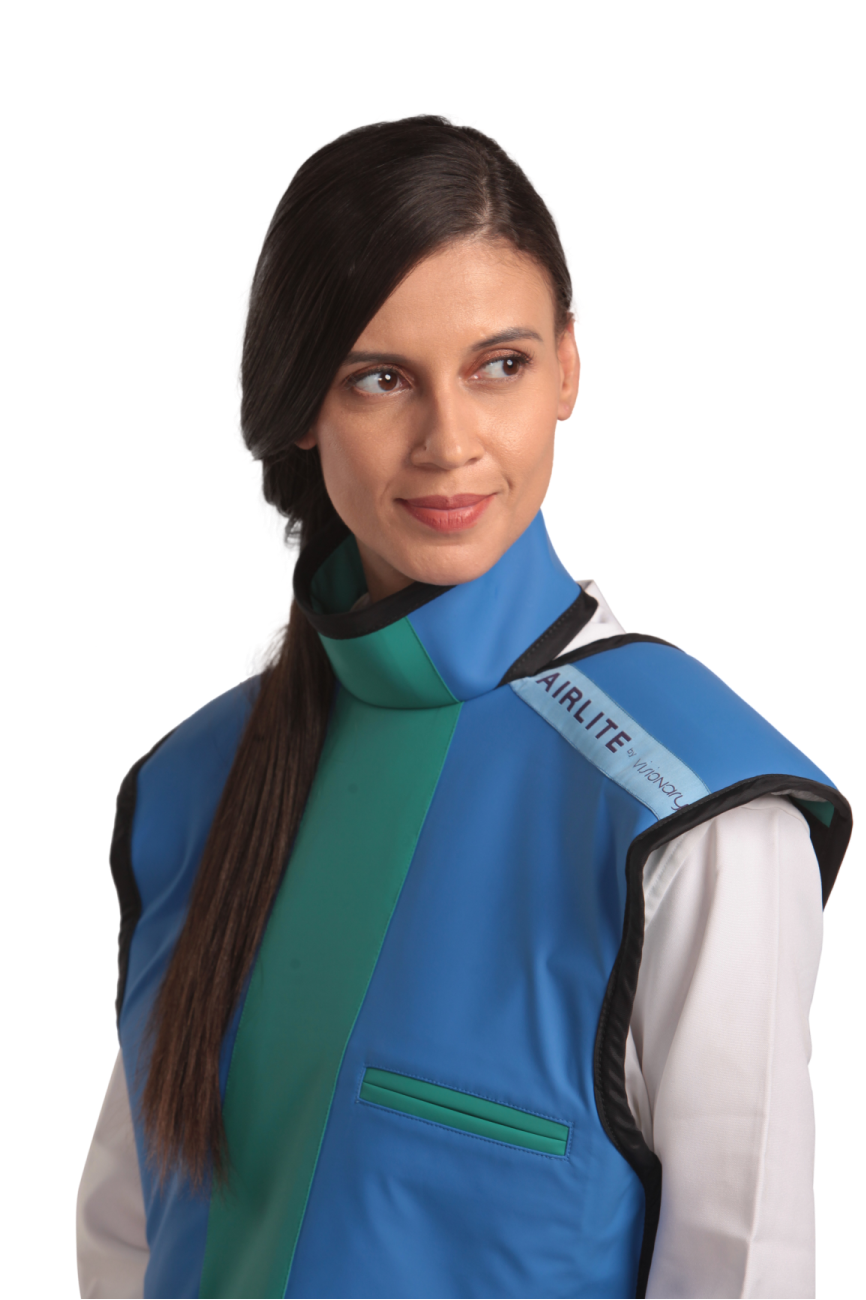 Half-length left-side frontal view of a female model wearing a coat apron with integrated thyroid guard. The apron is Royal blue in color with an ocean green center line.