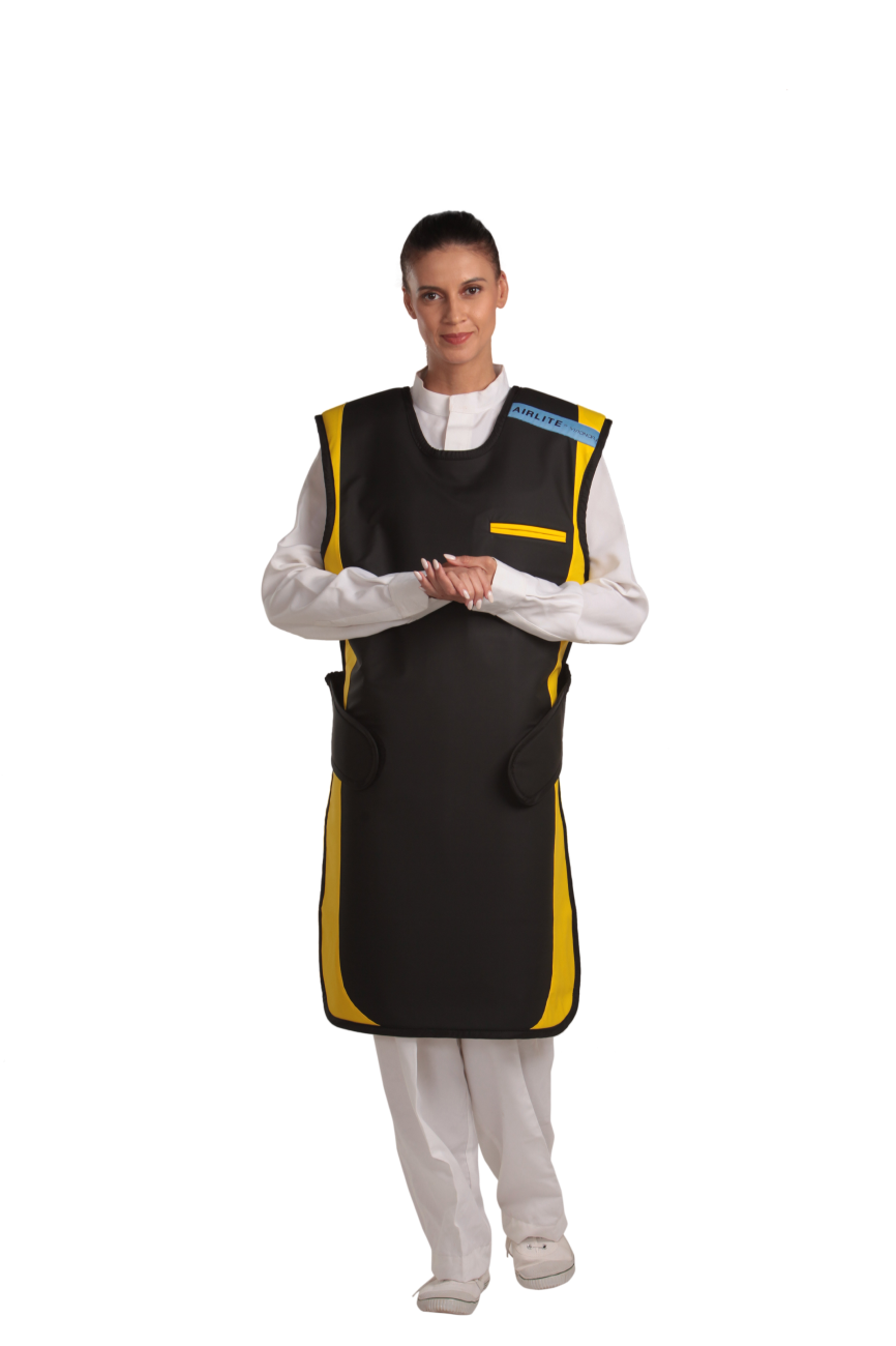 A full frontal view of a female model, her two hands clasped together below her chest, wearing a jet black, yellow-lined coat apron with flex back