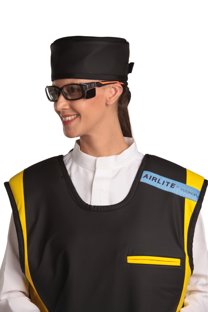 Up-close view of a female model wearing a radiation protection head shield, eyewear, and a coat apron. The apron is jet-black with yellow-colored lines by the edges.