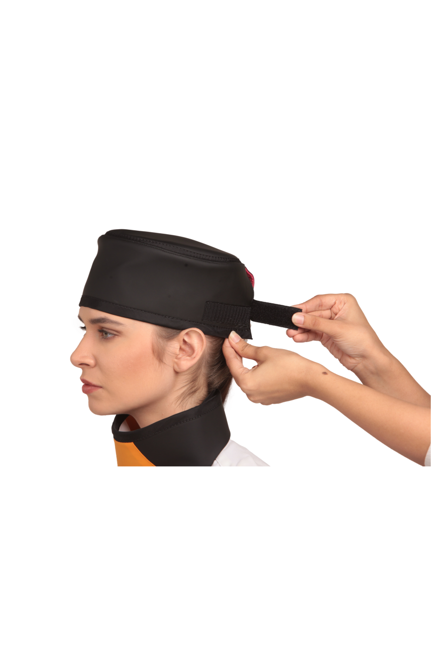 Up-close view of a black radiation protection head shield being fastened onto the head of a female model.