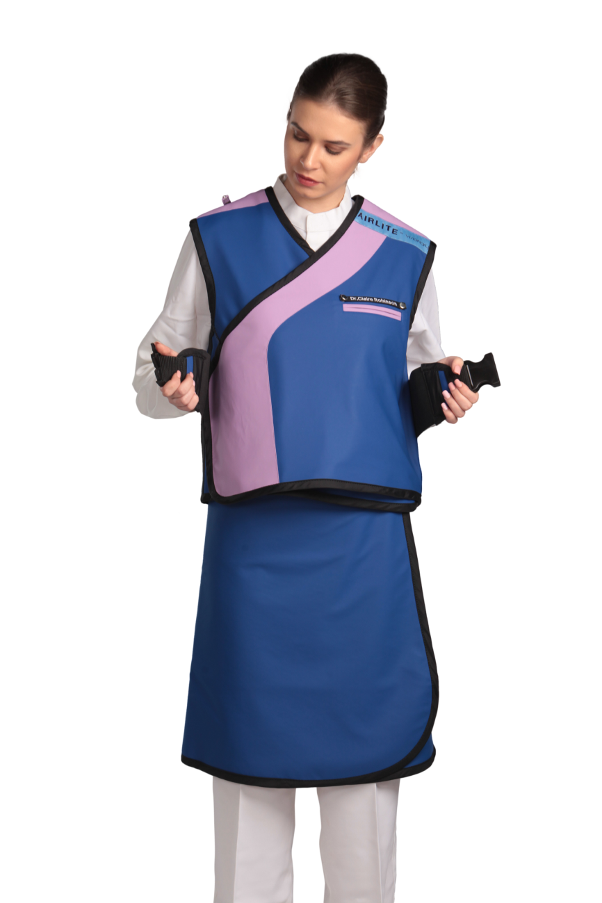 Full frontal view of a female model wearing an Electric blue radiation protection skirt and vest. The vest is electric blue with lilac lines around the left edge and side paracord buckles the model is trying to fasten to the front.