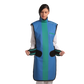 Full frontal view of a female model wearing a coat apron with integrated thyroid guard. The apron is royal blue in color with an ocean green center line and has open velcro fasteners held in the model's hands by the sides.