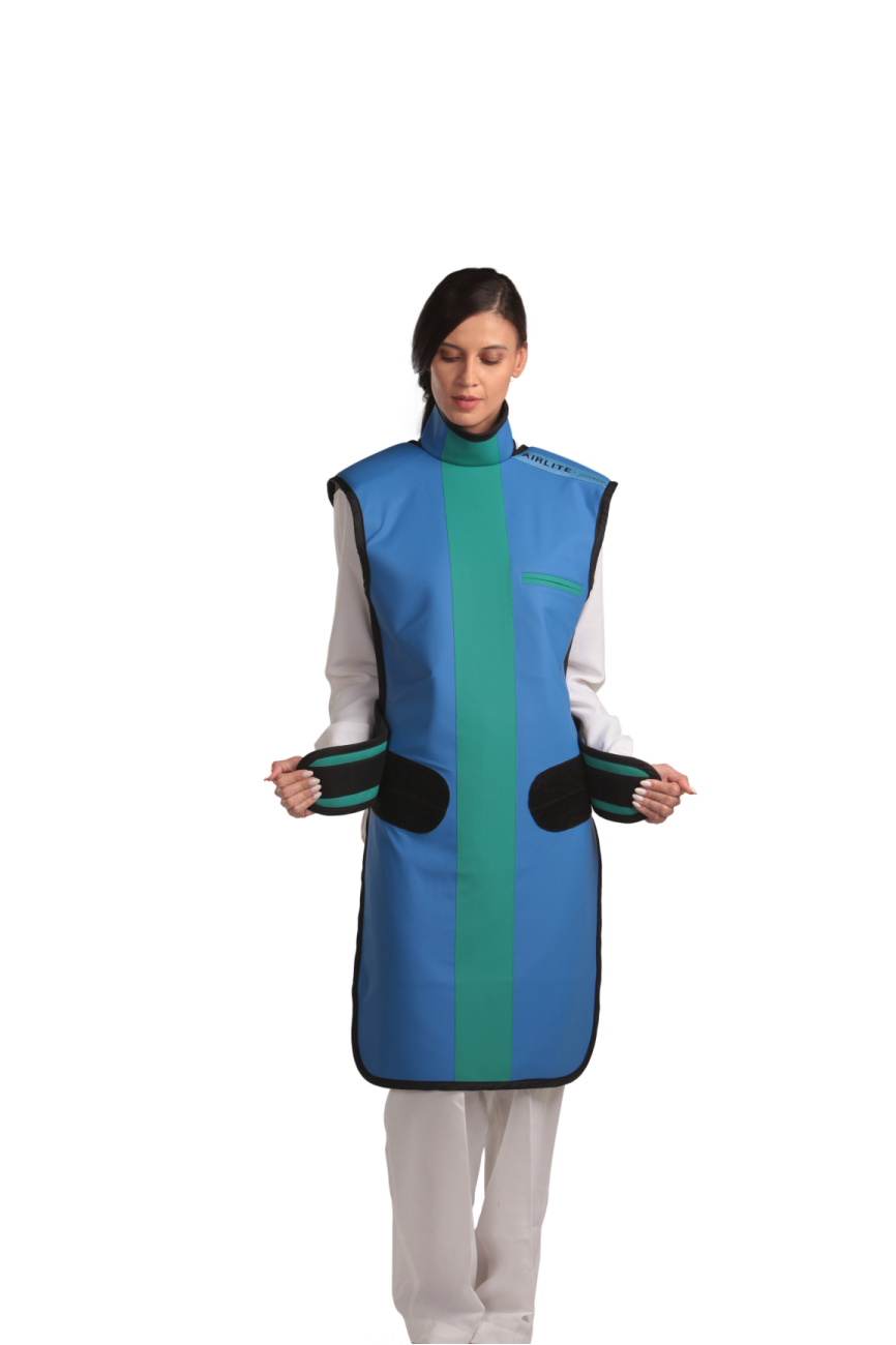 Full frontal view of a female model wearing a coat apron with integrated thyroid guard. The apron is royal blue in color with an ocean green center line and has open velcro fasteners held in the model's hands by the sides.