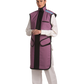 A left-side frontal view of a female model, her two hands clasped together below her chest, wearing a coat apron with an integrated thyroid guard. The apron is mauve in color with a Jet black center line and has closed velcro fasteners by the sides.