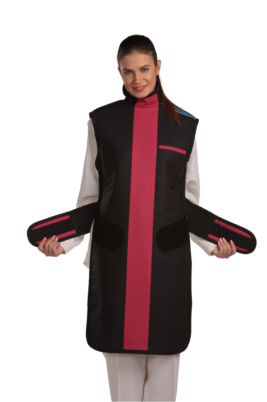 Ankle-length frontal view of a female model wearing a coat apron with integrated thyroid guard. The apron is Jet black with a Bordeaux red center line and has unfastened velcro fasteners held in the model's hands.