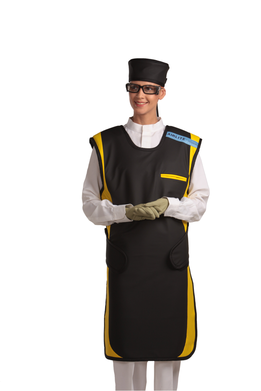 A full frontal view of a female model wearing a black, yellow-lined coat apron with flex back, a black head shield, and a protective eyewear. Her hands are clasped below her chest. 