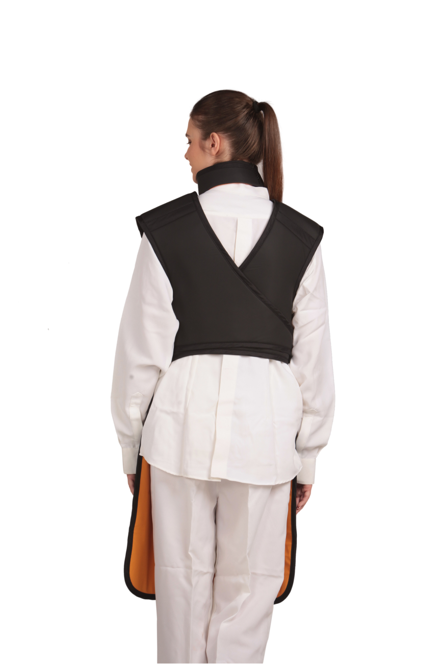 A full back view of a female model wearing a black, orange-lined coat apron with flex back.