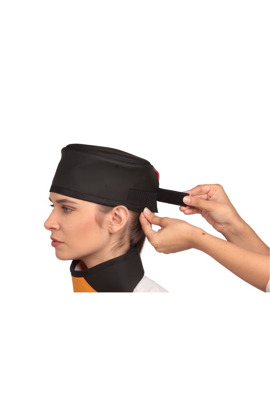 Up-close view of a black radiation protection head shield being fastened onto the head of a female model. 