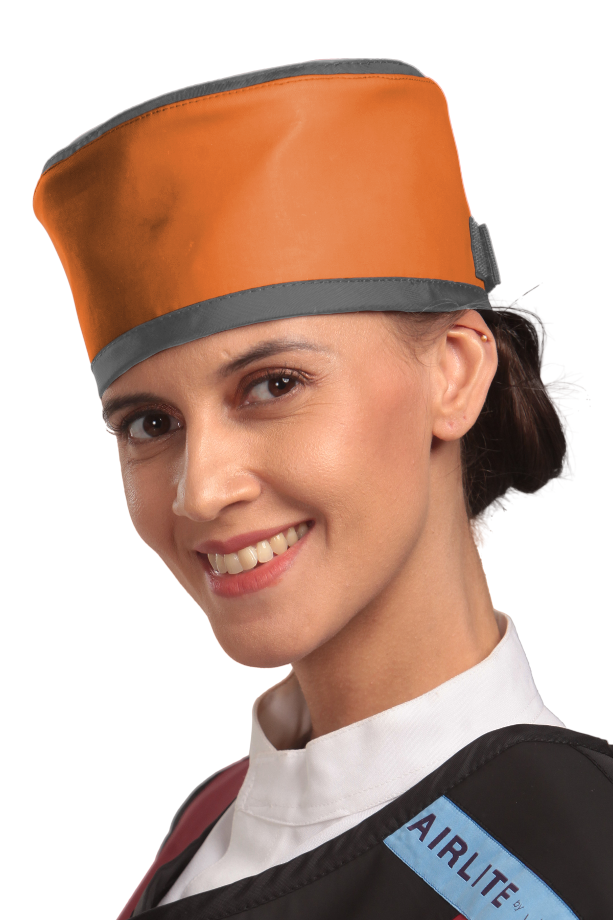 Up-close left-side frontal view of a female model wearing a radiation protection head shield. The head shield is Tangerine with grey-colored lines around the lower and upper edges.