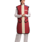 A full frontal view of a female model, her two hands clasped together below her chest, wearing a bordeaux red, beige center-lined coat apron with integrated thyroid guard.
