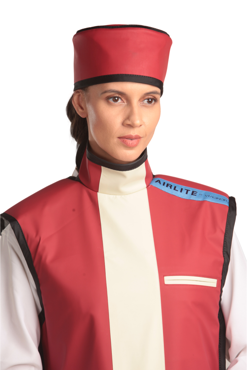 Frontal half-length view of a female model wearing a red radiation protection head shield and a coat apron with integrated thyroid guard.