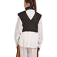 A full back view of a female model wearing a black, orange-lined coat apron with flex back.