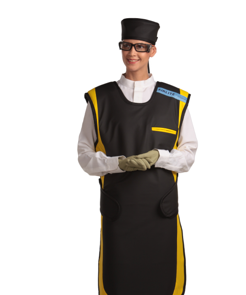 Frontal view of a female model, her hands clasped together below her chest, wearing a radiation protection head shield, eyewear, medical gloves, and a coat apron. The apron is Jet black with a yellow-colored center line and has closed velcro fasteners by the sides.