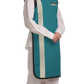 Right partial frontal view of a female model wearing an ocean green, beige-lined coat apron with flex back.